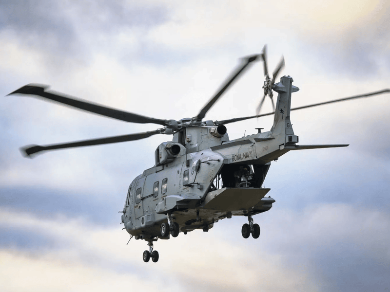 Aircrewman operating a general purpose machine gun from a Merlin Mk4 helicopter.