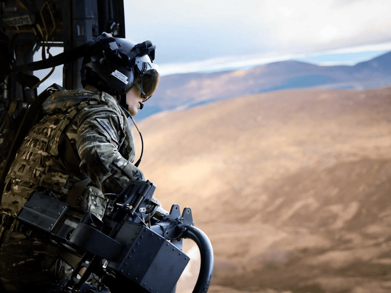 Aircrewman working inside a Merlin Mk4 helicopter during mountain flying training.
