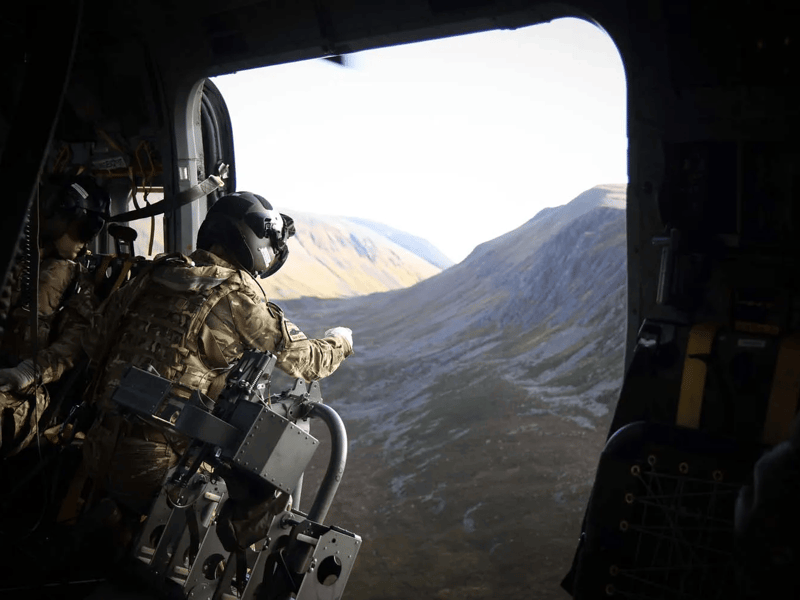Aircrewman working inside a Merlin Mk4 helicopter during mountain flying training.