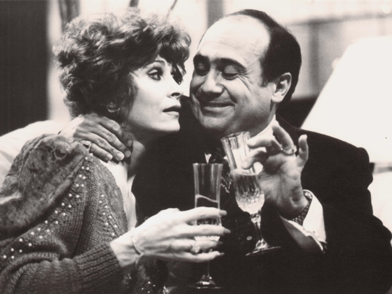 In the 1986 comedy 'Ruthless People,' Danny DeVito plays Sam Stone, a selfish, unscrupulous businessman who plans to murder his wealthy wife, Barbara (Bette Midler), to inherit her fortune. However, his plans are hilariously derailed when amateur criminals kidnap Barbara, expecting a hefty ransom. Instead of rescuing her, Sam sees the kidnapping as a solution to his problem and refuses to pay, setting off a chaotic series of events. DeVito’s performance as the conniving and unapologetically ruthless Sam is central to the film’s dark comedic tone.