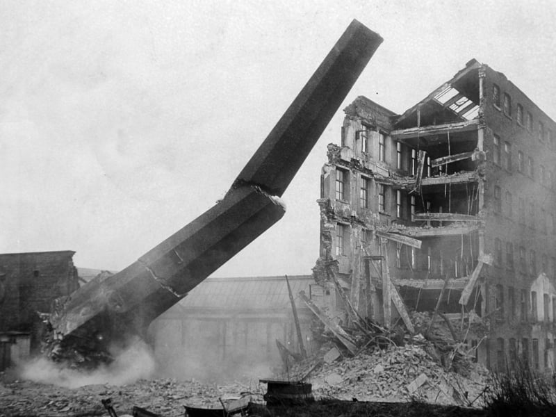 One of the chimney stacks at Bean Ing Mills on Wellington Street being demolished.