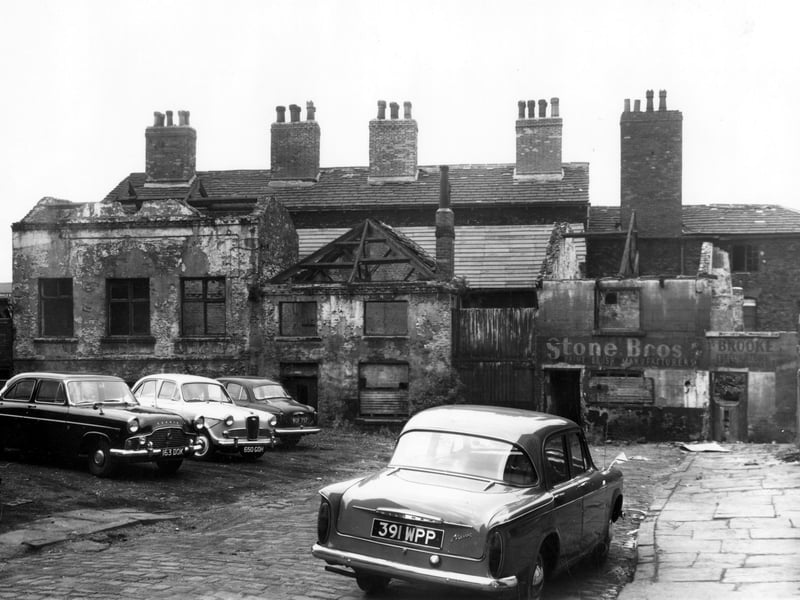 North Place which was off North Street. Derelict property remains, some had already been demolished. Former premises of Stone Bros, paint brush manufacturers can be seen towards the right. The site is being used as a car park, a Ford Zephyr can be seen on the left, to the right, a Hillman Minx. Pictured in October 1962.