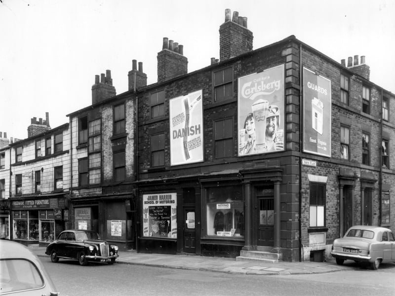 North Street, once known as Sheepscar Lane, was the route for stage-coaches going to the North of Leeds. Number 164/162 is an empty double fronted shop, previously the premises of J.Holder clothing manufacturer. A black car is parked outside. Next, moving right, is number 160, James Harris Driving School. Then on the corner with North Place, number 158, Direct Clothing Store. Pictured in October 1962.