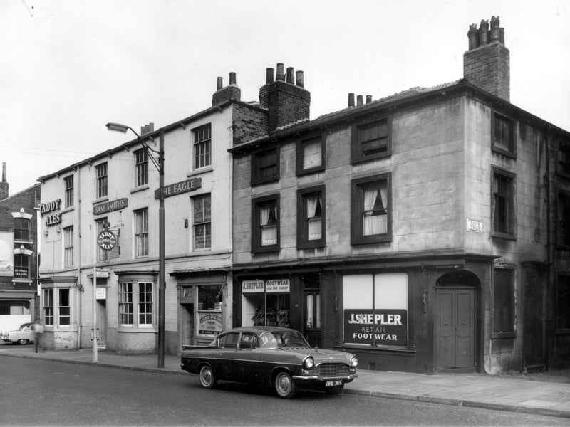 To the left is the corner with Benson Street, then the Eagle Tavern pub. S. B. London's Cutting Service is number 184, next to the right bay window of the Eagle. Goldie Shepler shoe shop has two units numbered 180. North Terrace is on the right, leading to a row of three Georgian houses.