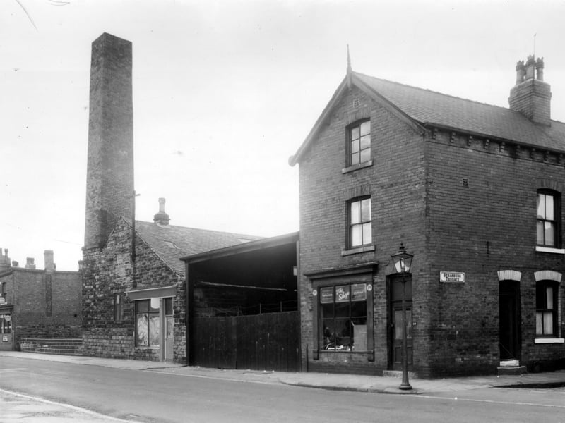 Sackville Street in October 1960. On the left edge is a cafe, 13/15 Sackville Street, the low wall is the edge of the road bridge over Sheepscar Beck. On older maps this is referred to as Oatlands Bridge. Next right, 17 is an old factory with a shop front, used as hair dressers. The yard was formerly used by Furniss removals.