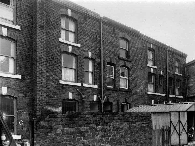 This is Ormonde Place, which was located behind Meanwood Road. Rear view of numbers 128 to 134, these properties had shop fronts on Meanwood Road. THe garage is behind number 130. On the right edge is the side of the Royal Cinema. Pictured in October 1960.