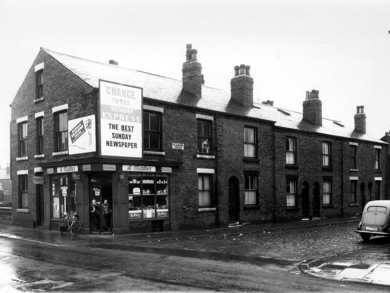On the left is the bridge over Sheepscar Beck, then 16 Sackville Street. This is a grocer's and sweet shop, business of R. Mather, two boys are in the shop doorway. Moving right on Wilmington Terrace are numbers 48 to 40, which is at the right side. These were through houses with access from Wilmington Grove. Pictured in October 1960.