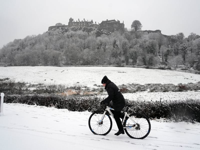 A person rides a bicycle in the snow at Stirling Castle. PIC: Andrew Milligan/PA Wire