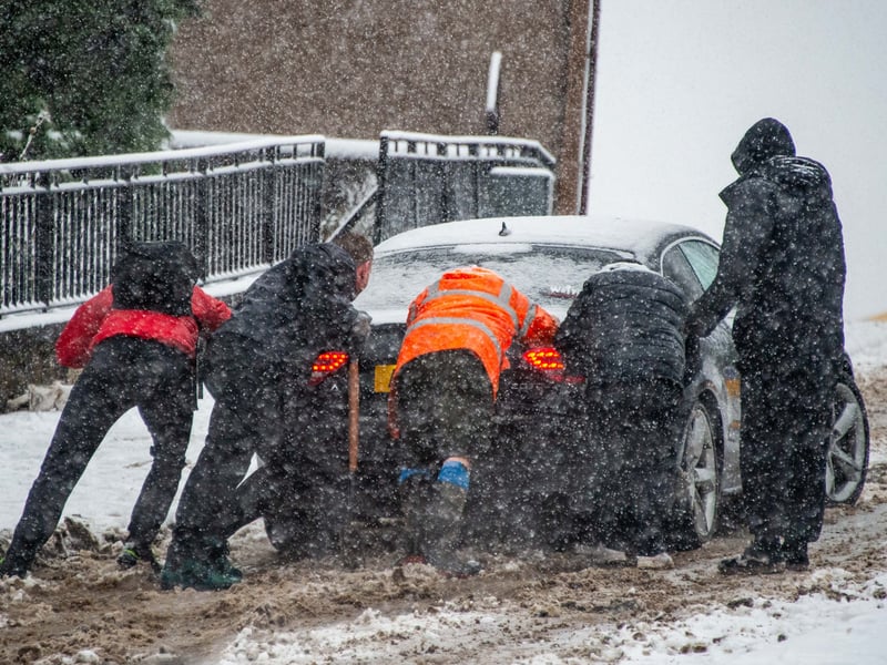Members of the public rally to help a driver stuck on the hill at the A803 at Bonnybridge. PIC: Lisa Ferguson.