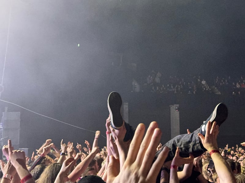 A crowd surfer makes his way to the stage.