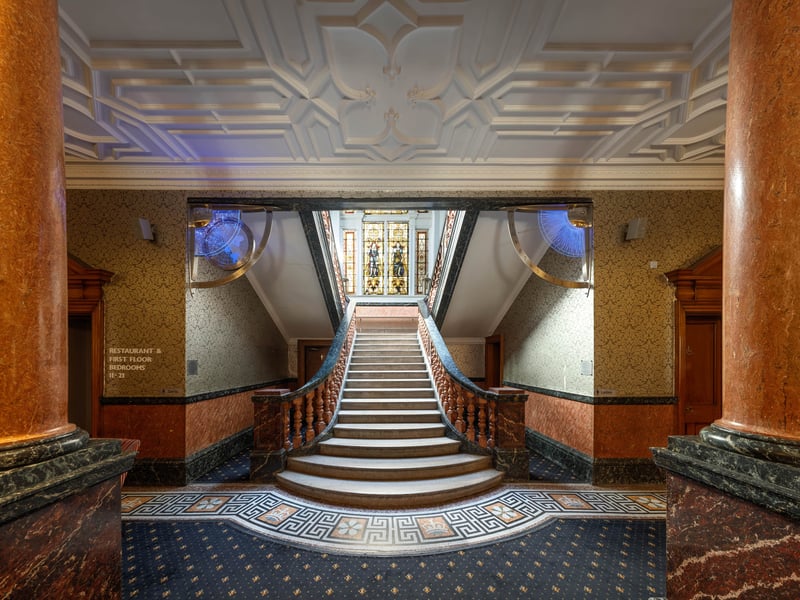The first thing people see when entering the historic building is a grand sweeping staircase and vaulted ceiling