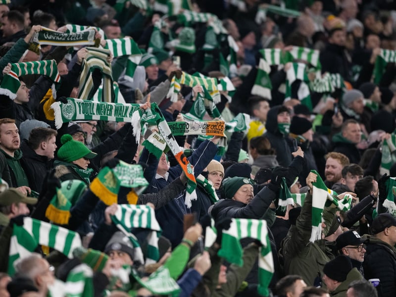 Celtic supporters lift their scarves above their heads as the teams enter the field at Celtic Park.