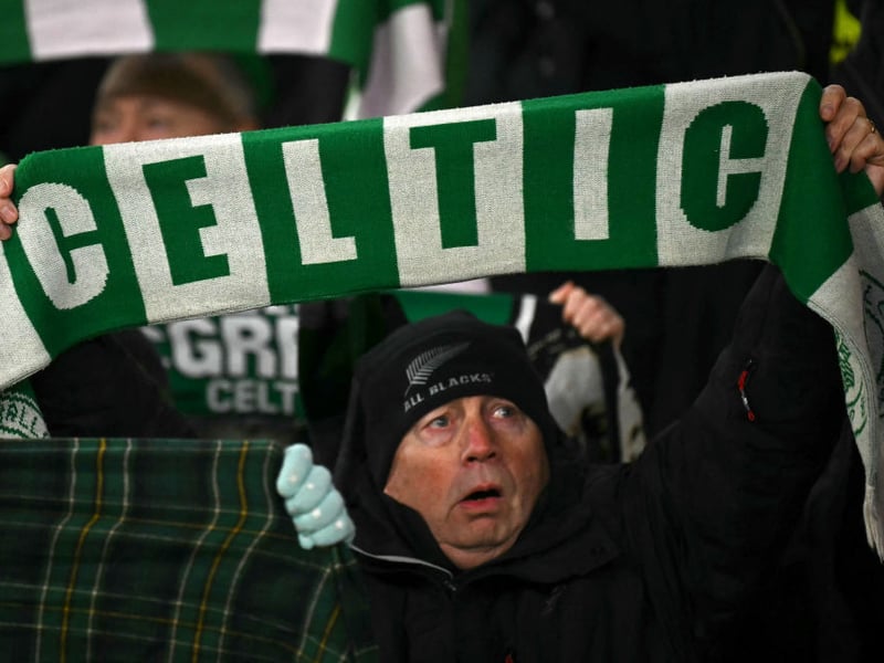 A Celtic supporter cheers on the team during a difficult first-half at Celtic Park.