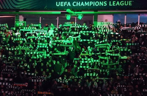 Celtic fans in the stands get into the pre-game atmosphere.