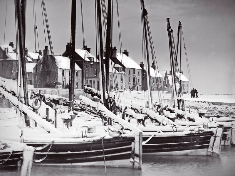 Snow stops sailing at St Monans in Fife in the early 1900s as heavy falls freeze the boats in the harbour.