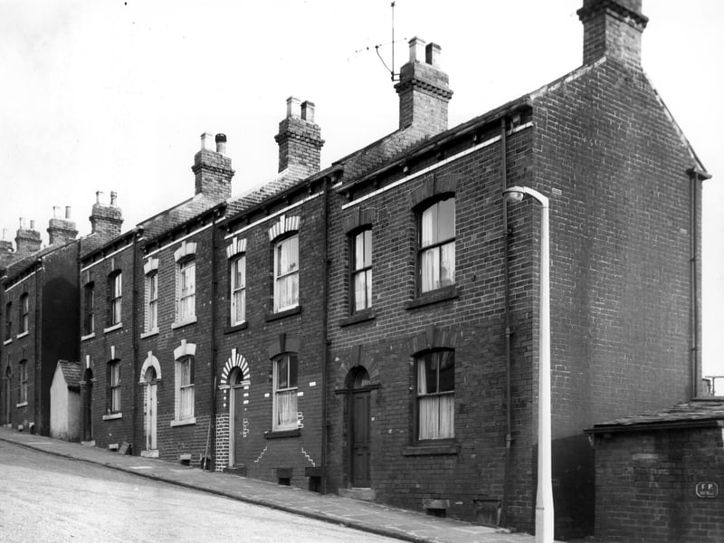 Silver Royd Street in October 1968. A row of four single fronted blind back terraced houses flanked by shared outside toilet yards.