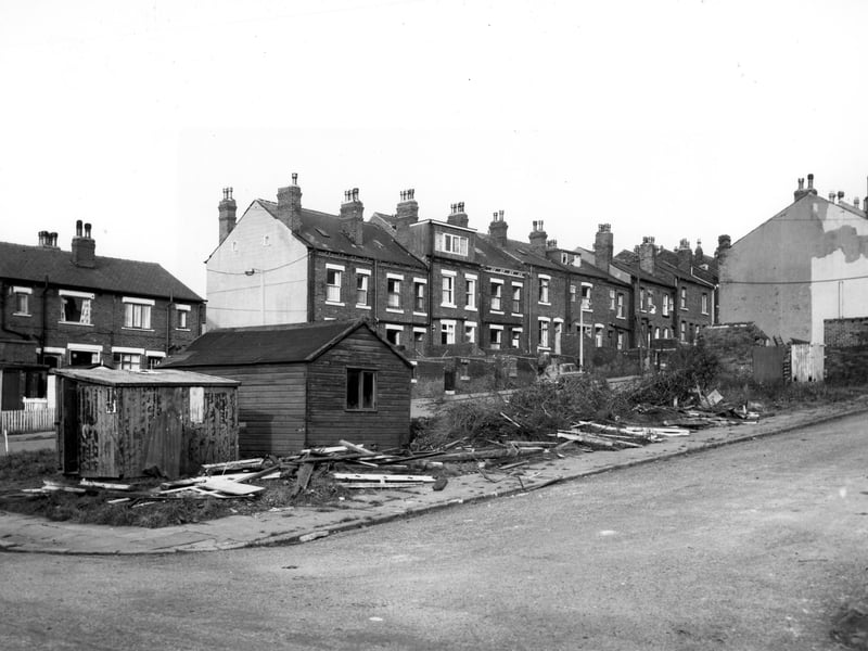 A couple of sheds built on waste land at the bottom of Silver Royd Avenue at the junction with Silver Royd Drive. Silver Royd Place is visible behind and the rear entrances and yards of through terraced houses numbers 41 to 59 Silver Royd Hill.