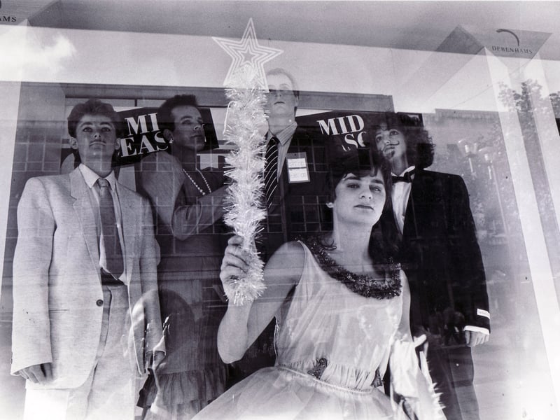 Rag students puzzle passing shoppers as they pose in the window of Debenhams on October 22, 1987