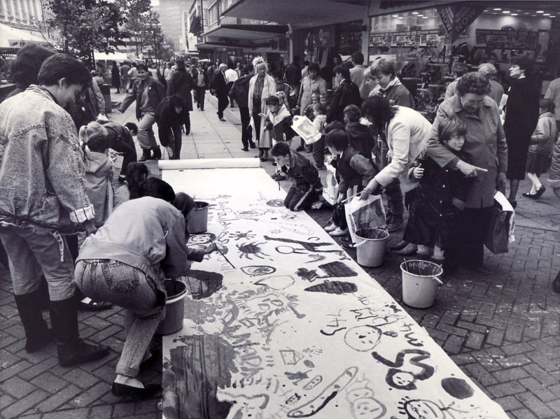 Moor the Merrier Week - 26th October 1987
Children take part in painting the longest mural on The Moor, Sheffield city centre, during the Moor the Merrier Week in October 1987
