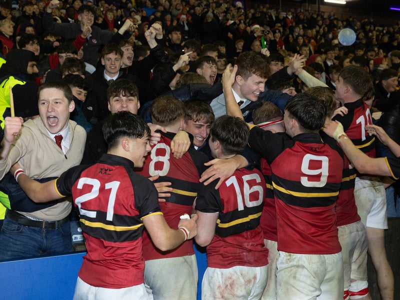 Stewart's Melville College players celebrate with fans after victory in the Under-18 Schools Cup final.