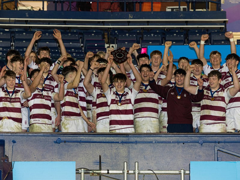 George Watson's College players celebrate with the trophy after winning the Under-18 shield.