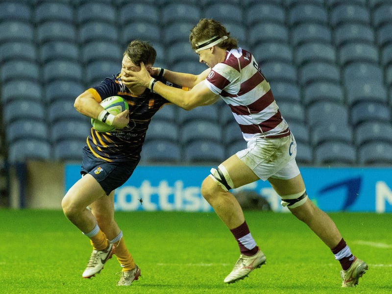Match action between George Watson's College (maroon and white hoops) and High School of Dundee during the Under-18 shield final at Murrayfield.