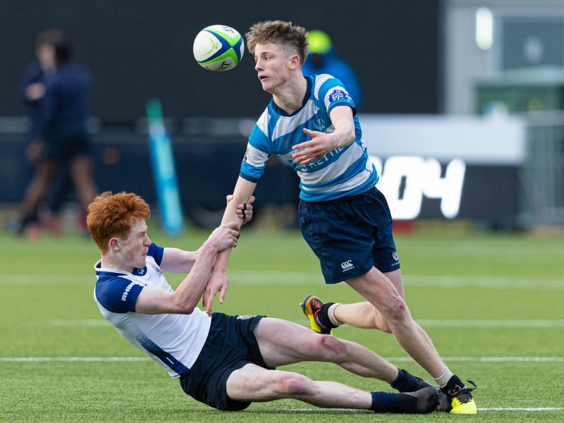 Match action between Edinburgh Academy (light blue and white hoops) and Dollar Academy during the Under-16 shield final.