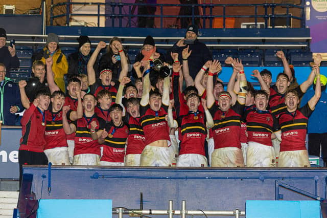 Stewart's Melville College players celebrate with the trophy at full time after the 2024 Boys' Schools Cup Finals win over Merchiston Castle at Murrayfield. (Photo by Mark Scates / SNS Group)