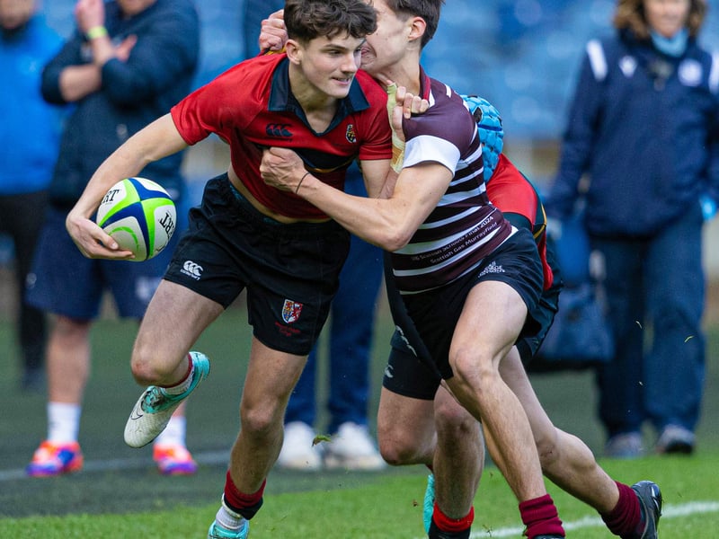 Match action between Stewart's Melville (red) and George Watson's during the Under-16 final at Murrayfield.