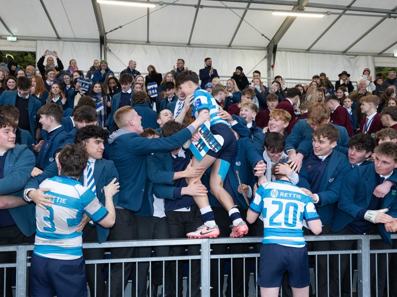 Edinburgh Academy players celebrate with fans at full time after defeating Dollar Academy in the Under-16 shield final.