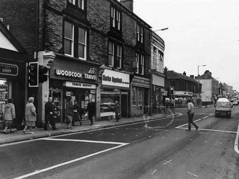 Shops on Middlewood Road, Hillsborough, in November 1985, including Woodcock Travel, travel agents; Charles Hagenbach and Sons, bakers; and Barclays Bank