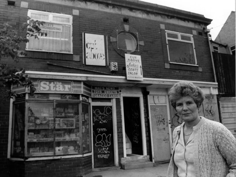 Pat Waller outside her newsagents shop, Mac's News, and Cut Above, gents hairdressing, on Wulfric Road, Manor, Sheffield, in June 1987
