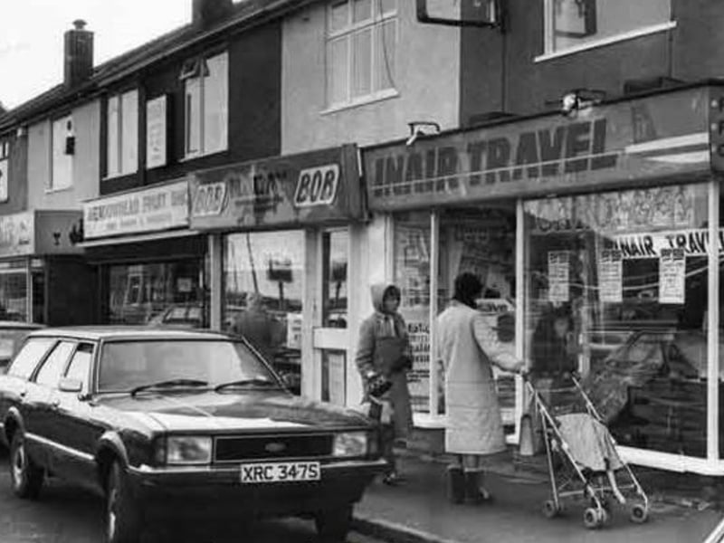 Shops on Meadowhead, Sheffield, in February 1983, including Mitchells, wine merchants; Meadowhead Fruit Shop and Inair Travel