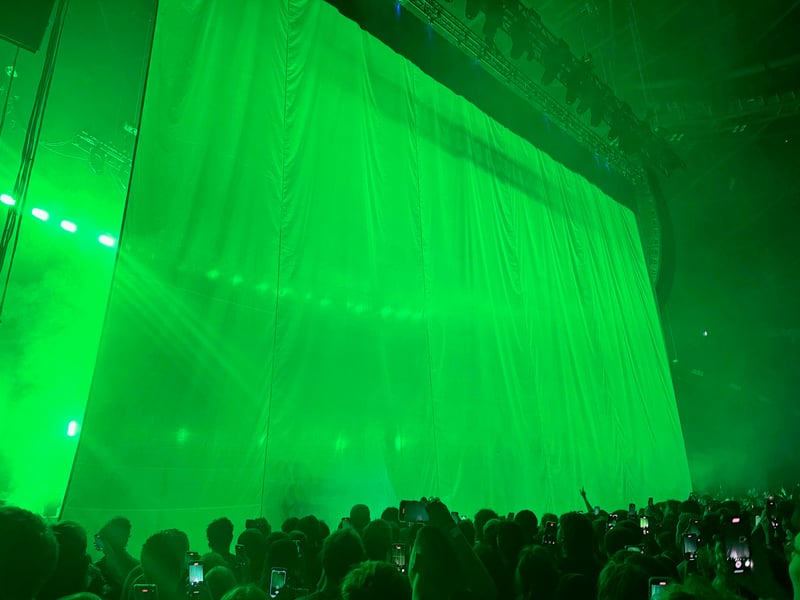 The band started the gig playing behind a curtain, building anticipation.