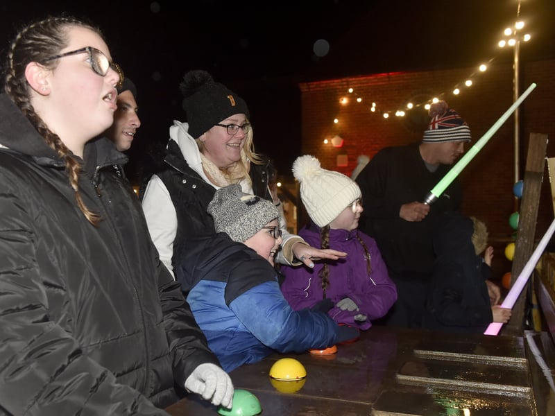 Pictured is: The Nevitt and Kean family from Gosport having a go at the games. Picture: Sarah Standing (081224-7414)