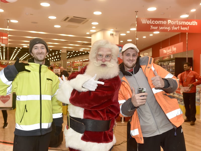 Pictured is: Father Christmas with (left) Jason Peter and Zack Boyd. Picture: Sarah Standing (121224-7656)