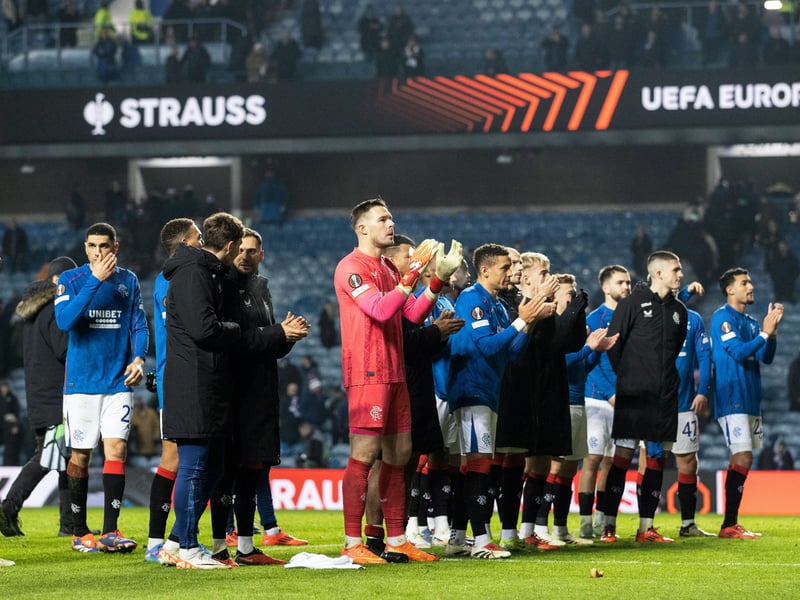 The Rangers players applaud their fans at full time.