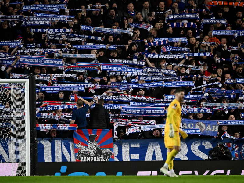 Rangers fans show their support with scarves during the game.
