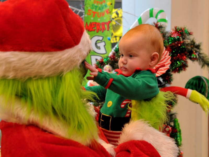 Little five-month-old Mya-Mae from Armley gets a close look at the Christmas Grouch.