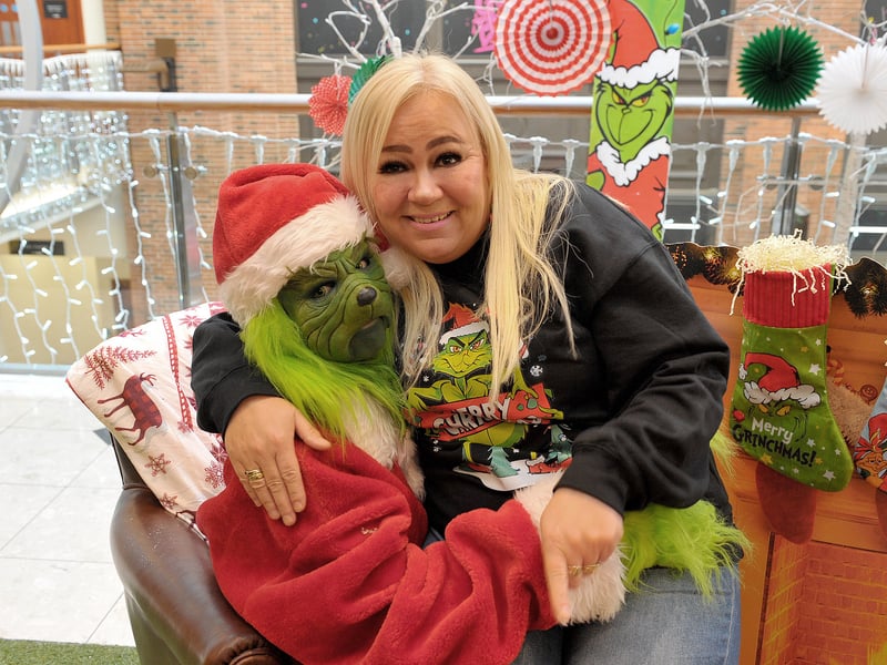 The Christmas Grouch enjoys a hug from Jeannie Wrigglesworth from Little London.