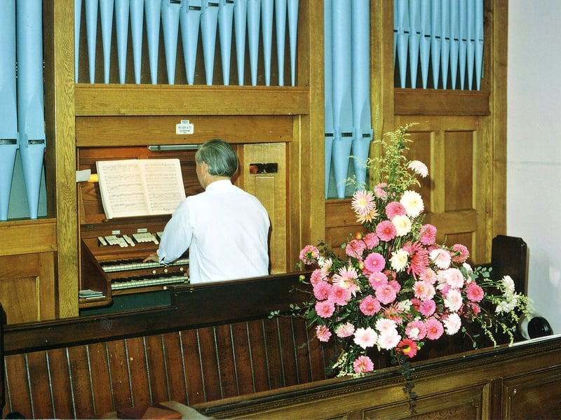 Inside Tingley Methodist Church on Westerton Road during a Flower Festival service in September 1971. The organist is Geoffery Dunn.