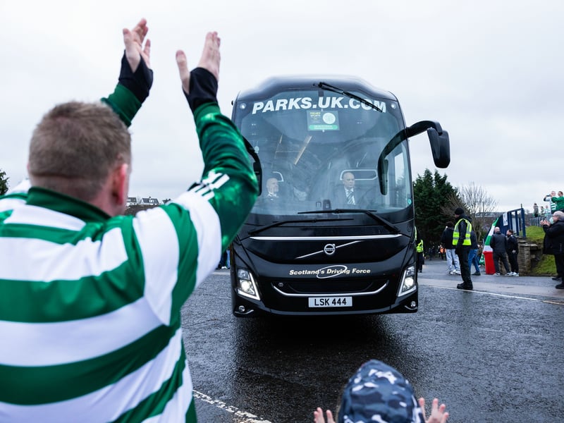 A Celtic fan welcomes the team bus to Hampden Park ahead of the game.