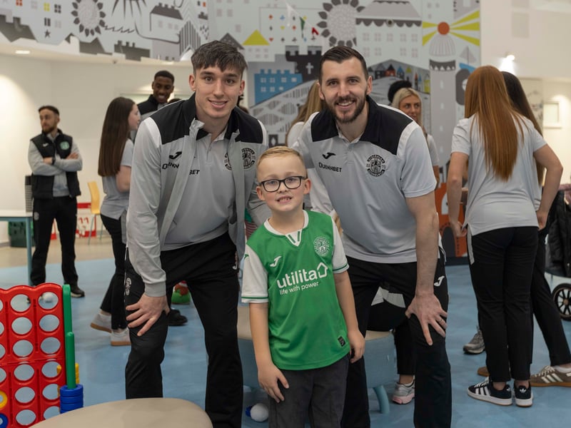 Kieron Bowie (left) and Jordan Smith pose with a young fan for a photo as players split up to see as many youngsters as possible.