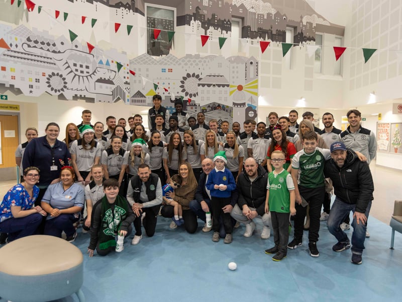 Players pose for a 'team photo' with patients, families and staff.