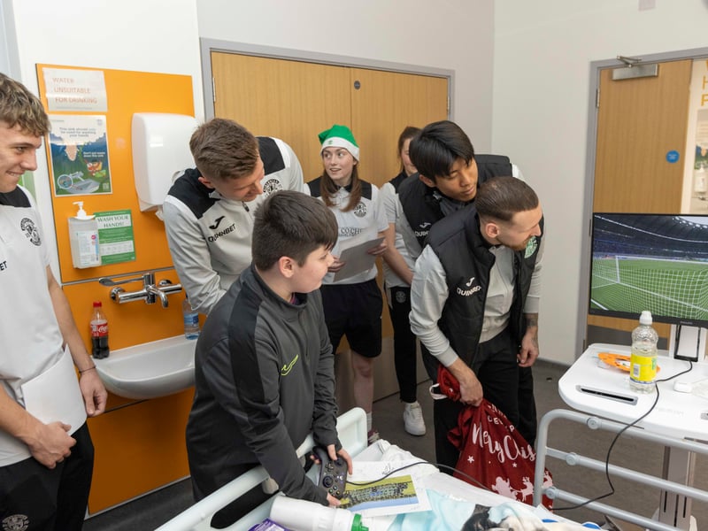 Hibs players watch as one young fan shows off his video game skills.
