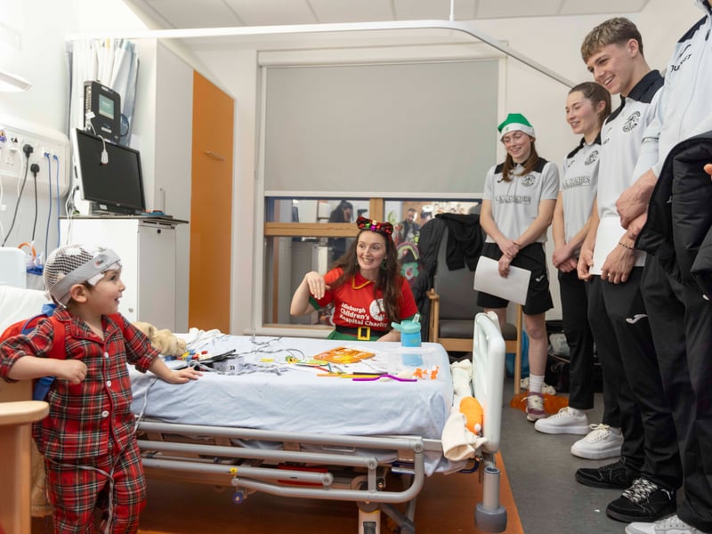 Aren't you guys a little big to be elves? This young patient seems surprised AND delighted by her visitors.