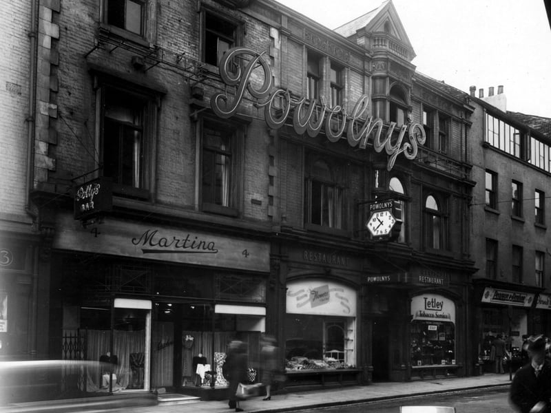 Bond Street, showing Powolny's restaurant in the centre. The entrance to the restaurant has an awning, with a six sided clock above. Pictured in June 1950.