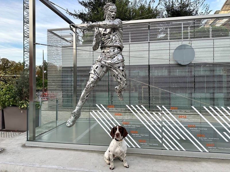 Police dog Cody next to the Rafael Nadal statue at Roland Garros.