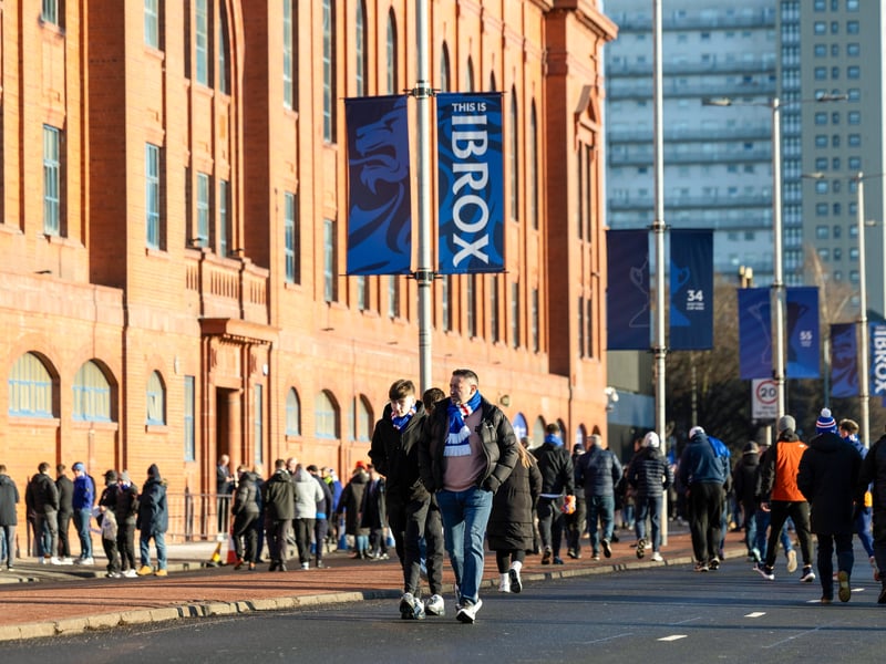 Fans arrive at the ground before the the game between Rangers and Celtic.