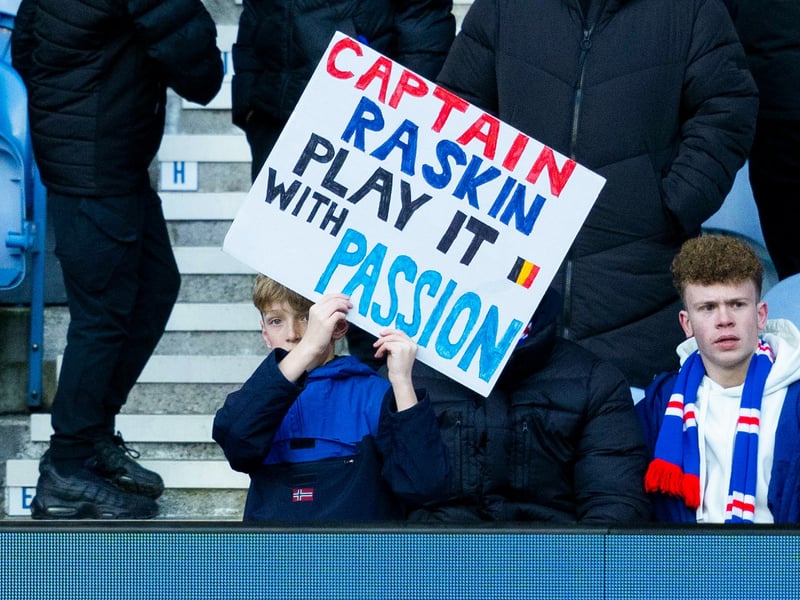 A young fan with a sign for Rangers captain for the day Nicolas Raskin.